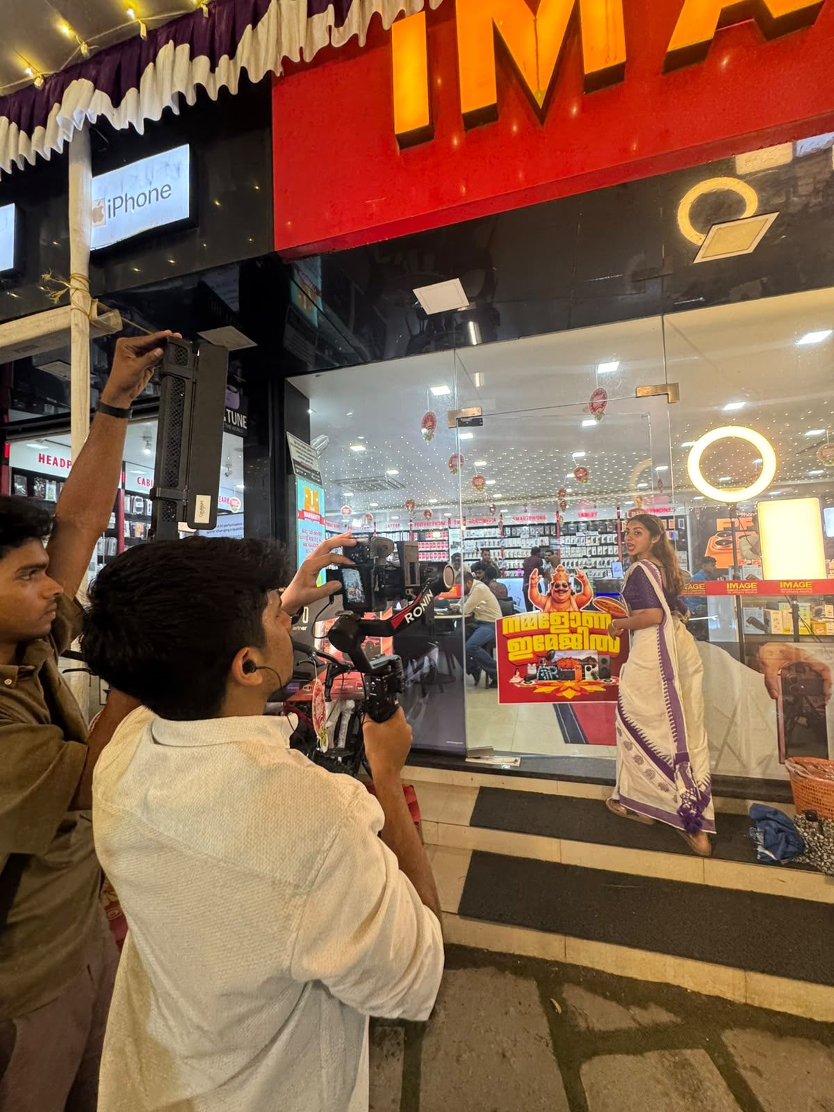 Behind the scenes filming the IMAGE Mobiles & Computers Onam campaign on location outside a store, with gimbal and camera crew